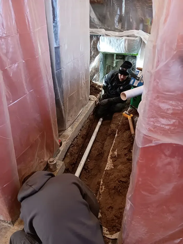 Hanna crew laying a new sewer line inside an Eastern Iowa home